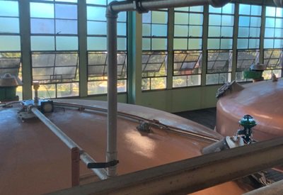 Fermentation vessels at a distillery use radar level sensors to monitor volume.