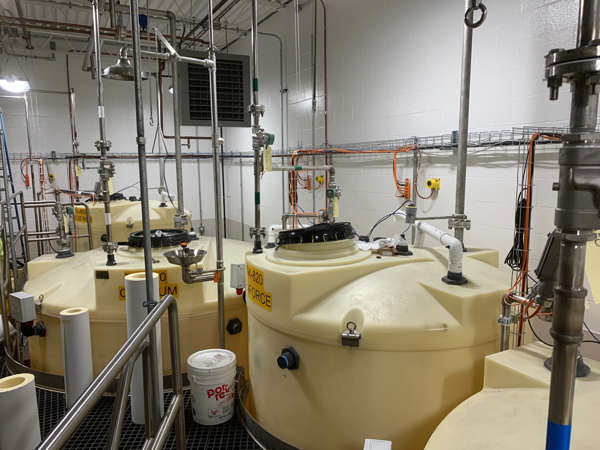 Large day tanks are used to fill the 55-gallon drums. Chemical level is tracked with a VEGAPULS C 11 radar sensor.